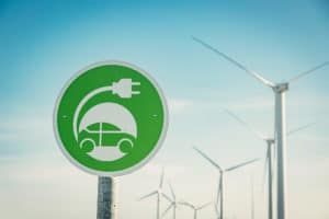 지속가능성 시대를 상징하는 전기자동차와 풍력 발전