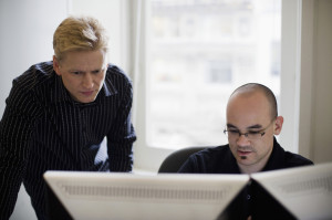Businessmen Looking at Computer Monitors
