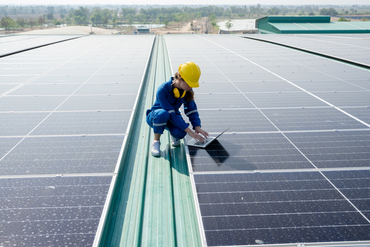 Engineer women working on solar rooftop.