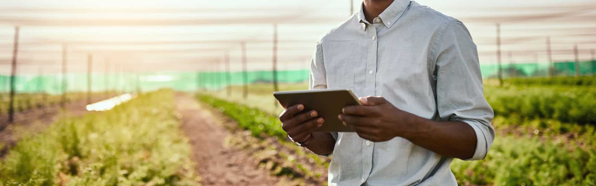Cropped portrait of a handsome young male farmer using a tablet while working on his farm