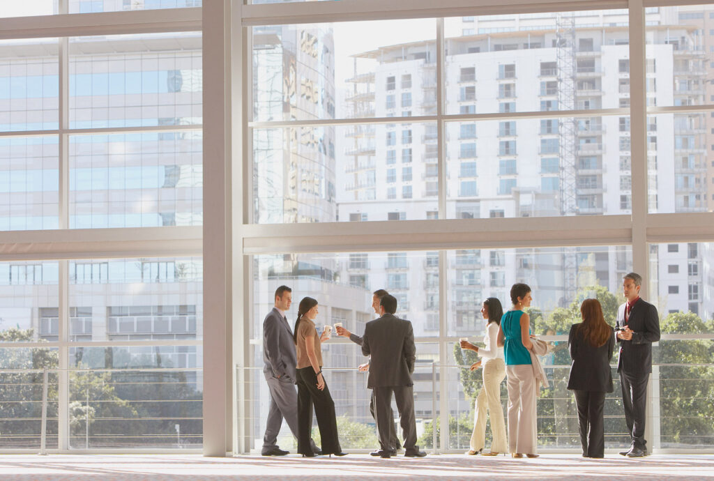 Group of businesspeople in front of large window