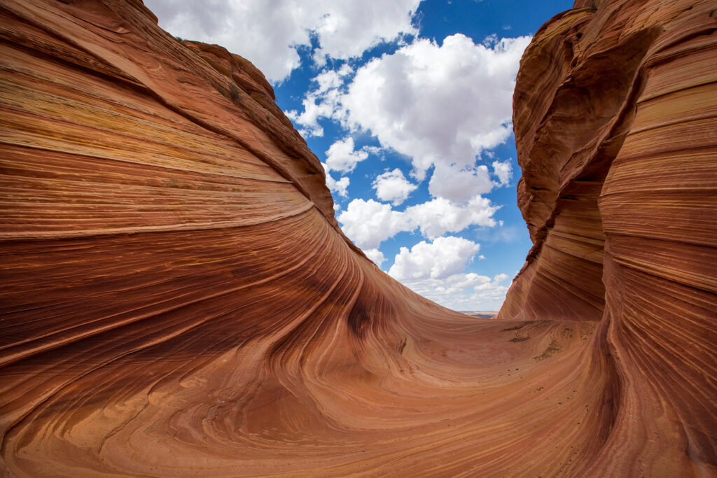 Grooves in desert rock formations with cloudy sky