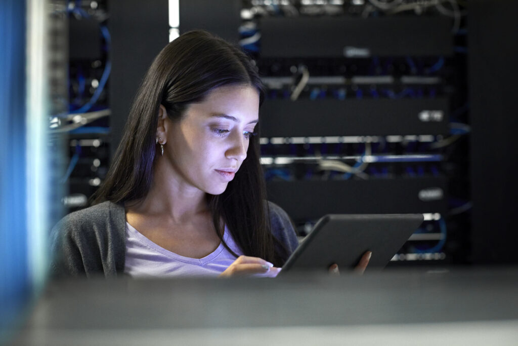 Female engineer working in server room