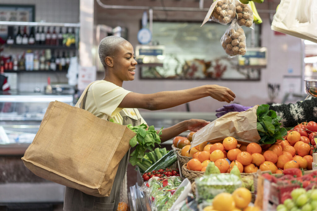 Woman buying groceries in a market hall