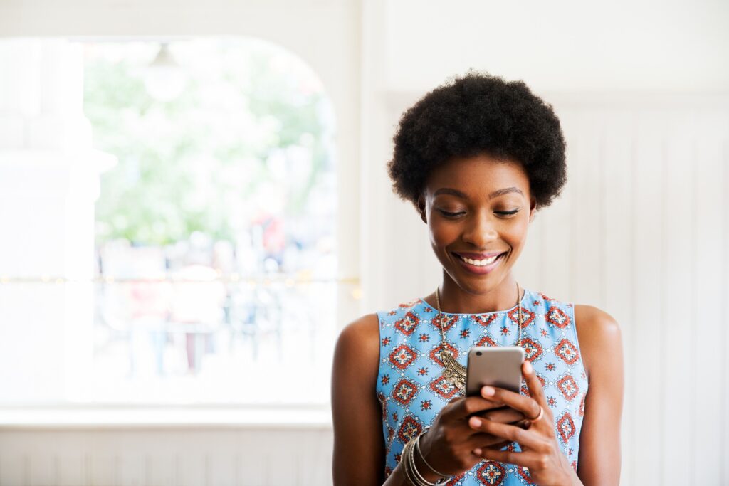 Woman smiling using smart phone