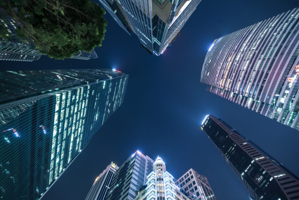 Night scene of looking up at skyscrappers at the heart of business district in Singapore