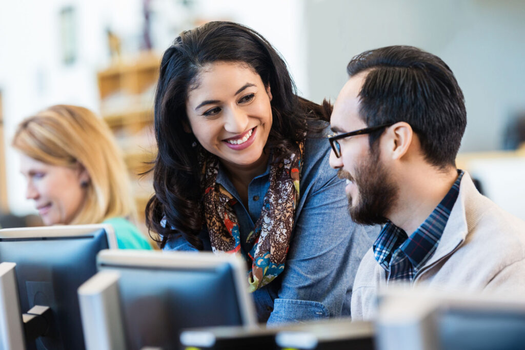 Two colleagues working together on computer