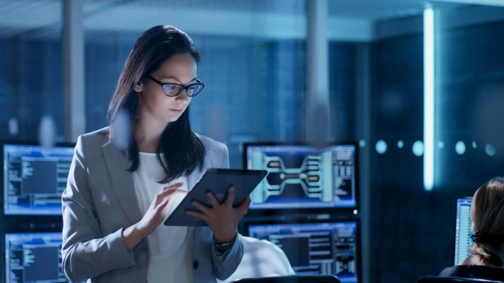 Woman using tablet in system control center