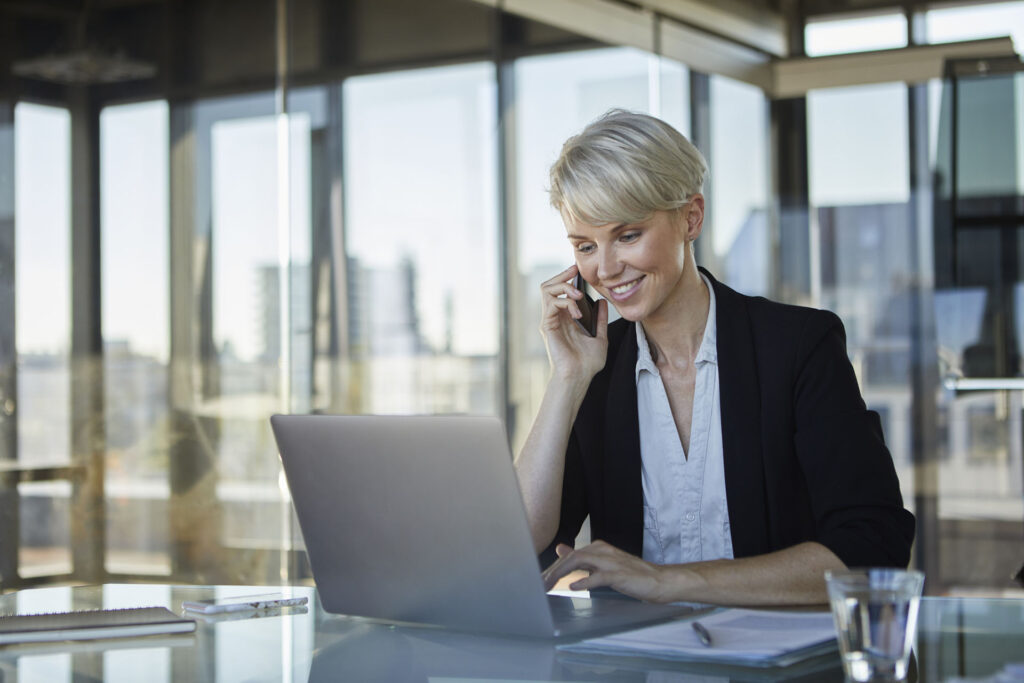 Smiling businesswoman working at desk in office