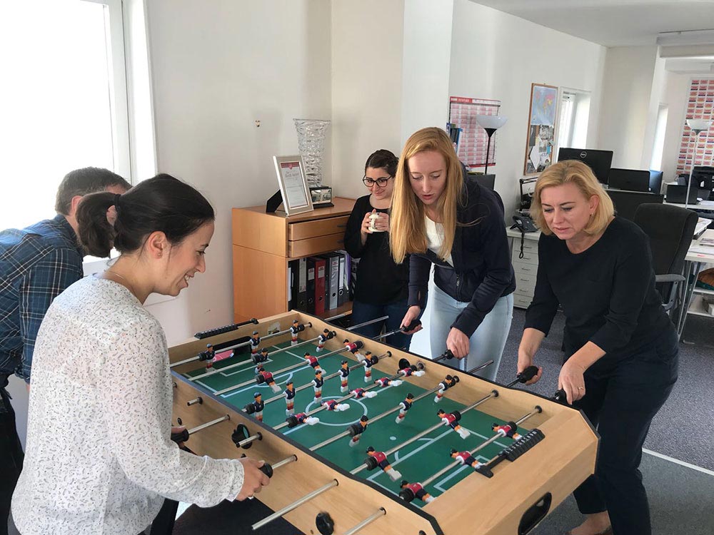 Colleagues playing table soccer